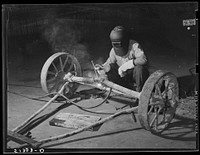 Welding axle. FSA (Farm Security Administration) warehouse depot. Atlanta, Georgia. Sourced from the Library of Congress.