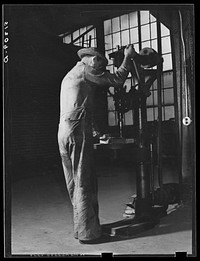 [Untitled photo, possibly related to: Repairing automobile motor. FSA (Farm Security Administration) warehouse depot. Atlanta, Georgia]. Sourced from the Library of Congress.