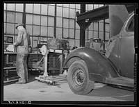 Repairing automobile motor. FSA (Farm Security Administration) warehouse depot. Atlanta, Georgia. Sourced from the Library of Congress.