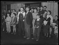 Group of rural people, including FSA (Farm Security Administration) clients watching recreational singing games at Mount Zion. Coffee County, Alabama. Sourced from the Library of Congress.