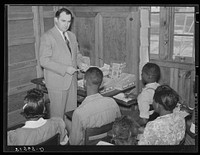 The school's junior cooperative store receives help and instructions in cooperative enterprises from a manager of the big project cooperative store. Gee's Bend, Alabama. Sourced from the Library of Congress.