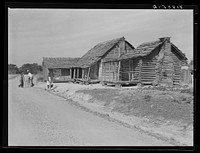 Old type of Gee's Bend, Alabama, home belonging to Mark and Angelina Parker. It is in three sections: guests or company house, sleeping house and kitchen. Sourced from the Library of Congress.