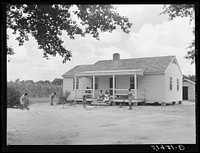 Children of Frederick Oliver, tenant purchase client, sweeping yard in front of new home. Summerton, South Carolina. Sourced from the Library of Congress.