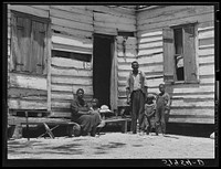 Mrs. Brown and family. She paid her taxes with oranges raised on her farm. Her husband worked in nearby oyster beds. The soil on the farm is better than usual in that section. Saint Helena Island, Beaufort, South Carolina. Sourced from the Library of Congress.
