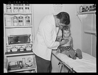 Examining child in medical center. Greenbelt, Maryland. Sourced from the Library of Congress.
