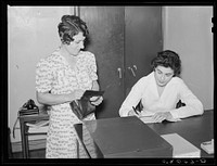 Woman making application for membership in Greenbelt medical association. Sourced from the Library of Congress.