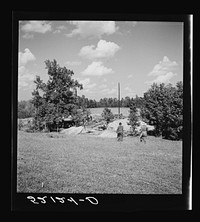 A portable cane mill (the owner gets every sixth gallon for making the sorghum syrup). This is on the property of a  owner, Wes Chris, a tobacco farm of about 165 acres in a prosperous Negro settlement near Carr, Orange County, North Carolina. See general caption notes on subregion, September 28, 1939. Sourced from the Library of Congress.