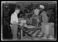 [Untitled photo, possibly related to:  day laborers brought in truck from nearby towns, waiting to be paid off for cotton picking and buy supplies inside plantation store on Friday night. Marcella Plantation. Mississippi Delta. Mississippi]. Sourced from the Library of Congress.