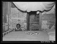 Interior of  tenant's home showing mosquito netting over bed. Mileston Plantation, Mississippi Delta, Mississippi. Sourced from the Library of Congress.