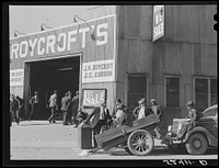 [Untitled photo, possibly related to: Many stories are exchanged by buyers and farmers while waiting around outside warehouse during auction sales. Durham, North Carolina]. Sourced from the Library of Congress.
