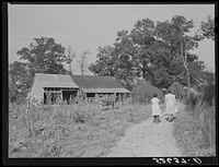 Two women of the Wilkins family by Mrs. Fred Wilkins barn on corn-shucking day. Tallyho, Stem, Granville County, North Carolina. Sourced from the Library of Congress.