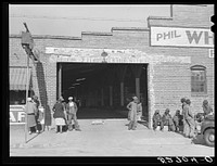 es waiting to go to work at one o'clock in warehouse and tobacco stem factory, Wendell, Wake County, North Carolina. Sourced from the Library of Congress.