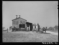 Joe Morgan, tenant on W.R. White farm, ready to leave the C.W. Lassiter gin with two bales of cotton on his wagon. Wake County, Wendell, North Carolina. Sourced from the Library of Congress.