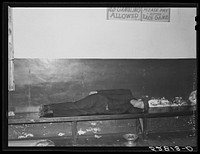 [Untitled photo, possibly related to: Farmers must often wait overnight or for several days before their tobacco is sold at auction. They sometimes hang around in cafes or pool rooms, sleeping most anywheres. Durham, North Carolina]. Sourced from the Library of Congress.