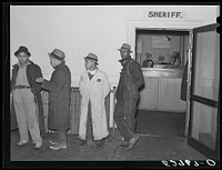 [Untitled photo, possibly related to: Men killing time in sheriff's office on court day, during dinner hour. Granville County County Courthouse, Oxford, North Carolina. See subregional notes (Odum) November 22, 1939]. Sourced from the Library of Congress.