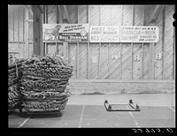 Baskets of tobacco piled on top of each other after being sold at auction. Here they are picked up by the trucks which haul them to the cigarette factories. This is in the Liberty warehouse. Durham, North Carolina. Sourced from the Library of Congress.
