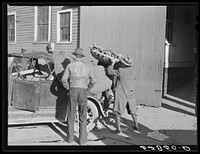 Farmer taking his tobacco from one warehouse to another for auction sale. Most of the warehouses are very rushed and quickly filled up the first of the week because most farmers think they get a better price on Monday or Tuesday. Mebane, Orange County, North Carolina. Sourced from the Library of Congress.