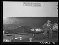 Farmers must often wait overnight or for several days before their tobacco is sold at auction. They sometimes hang around in cafes or pool rooms, sleeping most anywheres. Durham, North Carolina. Sourced from the Library of Congress.