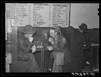 [Untitled photo, possibly related to: Farmers must often wait overnight or for several days before their tobacco is sold at auction. They sometimes hang around in cafes or pool rooms, sleeping most anywheres. Durham, North Carolina]. Sourced from the Library of Congress.