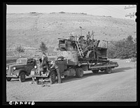 Truck used for transporting combine. Garfield County, Washington. Combines are often taken to town repair shops by this means and sometimes wheat farmers rent out or share combines by Russell Lee