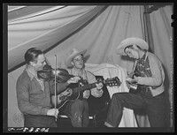 [Untitled photo, possibly related to: Singing cowboy songs at entertainment at the FSA (Farm Security Administration) mobile camp for migratory farm workers. Odell, Oregon] by Russell Lee