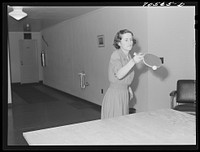 [Untitled photo, possibly related to: Woman that works at the Navy shipyards in the community room for women at the FSA (Farm Security Administration) duration dormitories. Bremerton, Washington] by Russell Lee