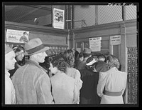 Lineup at general delivery window at the post office in Hermiston, Oregon. This post office served about eight hundred people a year ago; now it has more than five thousand general delivery patrons by Russell Lee