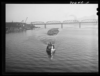 [Untitled photo, possibly related to: Log rafts are towed by tugs in the Willamette River. Portland, Oregon] by Russell Lee