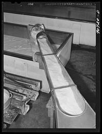 Milk pouring into vats where it will be processed into cheese. Tillamook cheese plant, Tillamook, Oregon by Russell Lee