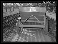 Salinas, California. Intercontinental Rubber Producers. Guayule planter. Seeds mixed with sawdust are planted by this machine which also distributes a thin stream of sand over the seeds. This is a nursery operation. Seedlings sprout in a few days, grow in the nursery about eight months before being transplanted into the field by Russell Lee