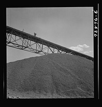 Shasta Dam, Shasta County, California. Pile of gravel under conveyor belt. The gravel will be used in construction of the dam by Russell Lee