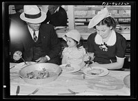 Portuguese-American family eat dinner at the fiesta of the Holy Ghost. Santa Clara, California by Russell Lee