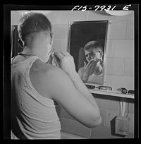 Fort Belvoir, Virginia. Sergeant George Camblair shaving in the morning at the camp. Sourced from the Library of Congress.