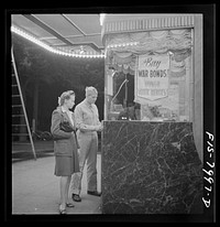 [Untitled photo, possibly related to: Washington, D.C. Sergeant George Camblair taking his girlfriend to the movies while he is at home on a weekend furlough]. Sourced from the Library of Congress.