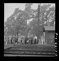 Silver Spring, Maryland. George Camblair waiting at the station for the train which will take him to the induction center. Sourced from the Library of Congress.