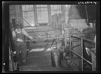 Butte, Montana. Anaconda Copper Mining Company. First step in making bits for a pneumatic drilling machine is to heat a rod of the proper size; this rod is placed into machine which punches and forms the bit; this process is called drop forging. Bit plant of the Anaconda Copper Mining Company by Russell Lee