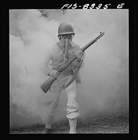 [Untitled photo, possibly related to: Fort Belvoir, Virginia. Sergeant George Camblair learning how to use a gas mask in a practice smokescreen]. Sourced from the Library of Congress.