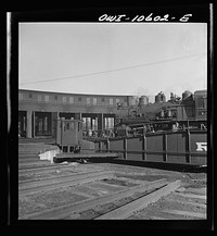 [Untitled photo, possibly related to: Chicago, Illinois. Track crews repairing tracks in the roundhouse at an Illinois railroad yard]. Sourced from the Library of Congress.