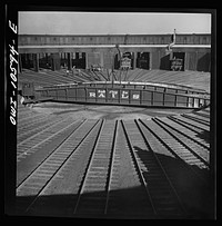 [Untitled photo, possibly related to: Chicago. Illinois. Track crews repairing tracks in the roundhouse at an Illinois Central Railroad yard]. Sourced from the Library of Congress.