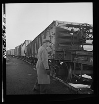 [Untitled photo, possibly related to: Chicago, Illinois. Uncoupling cars as they go over the hump at an Illinois Central Railroad yard]. Sourced from the Library of Congress.