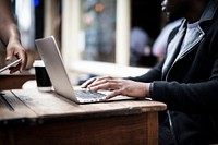 Businessman working remotely from a cafe