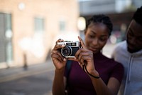 Woman using an analog film camera