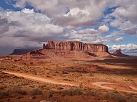 Scene in the Arizona portion of Monument Valley, a desert region on the Arizona-Utah border known for the towering sandstone buttes of Monument Valley Navajo Tribal Park. The park, frequently a filming location for Western movies, is accessed by the looping, 17-mile Valley Drive.