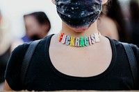 Protester wearing a Fuck Racism necklace at the Black Lives Matter protest in downtown Los Angeles.  8 JUL, 2020, LOS ANGELES, USA