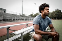 Man sitting by the stadium 