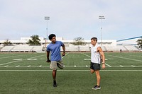 Athlete and coach stretching together