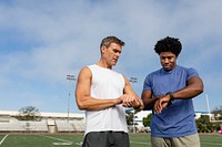 Athlete and coach discussing fitness tracker and performance