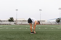 Man stretching in forward fold before exercise