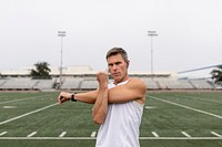 Man warming up by stretching before exercise