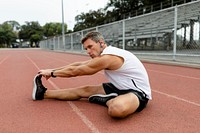 Man warming up by stretching before exercise